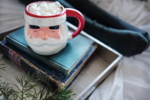 santa mug on pile of books