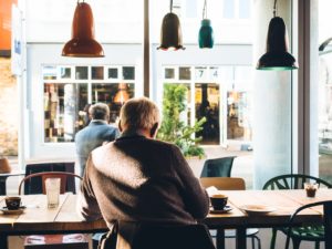 senior man sitting at table