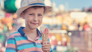 little boy eating a dripping ice cream cone